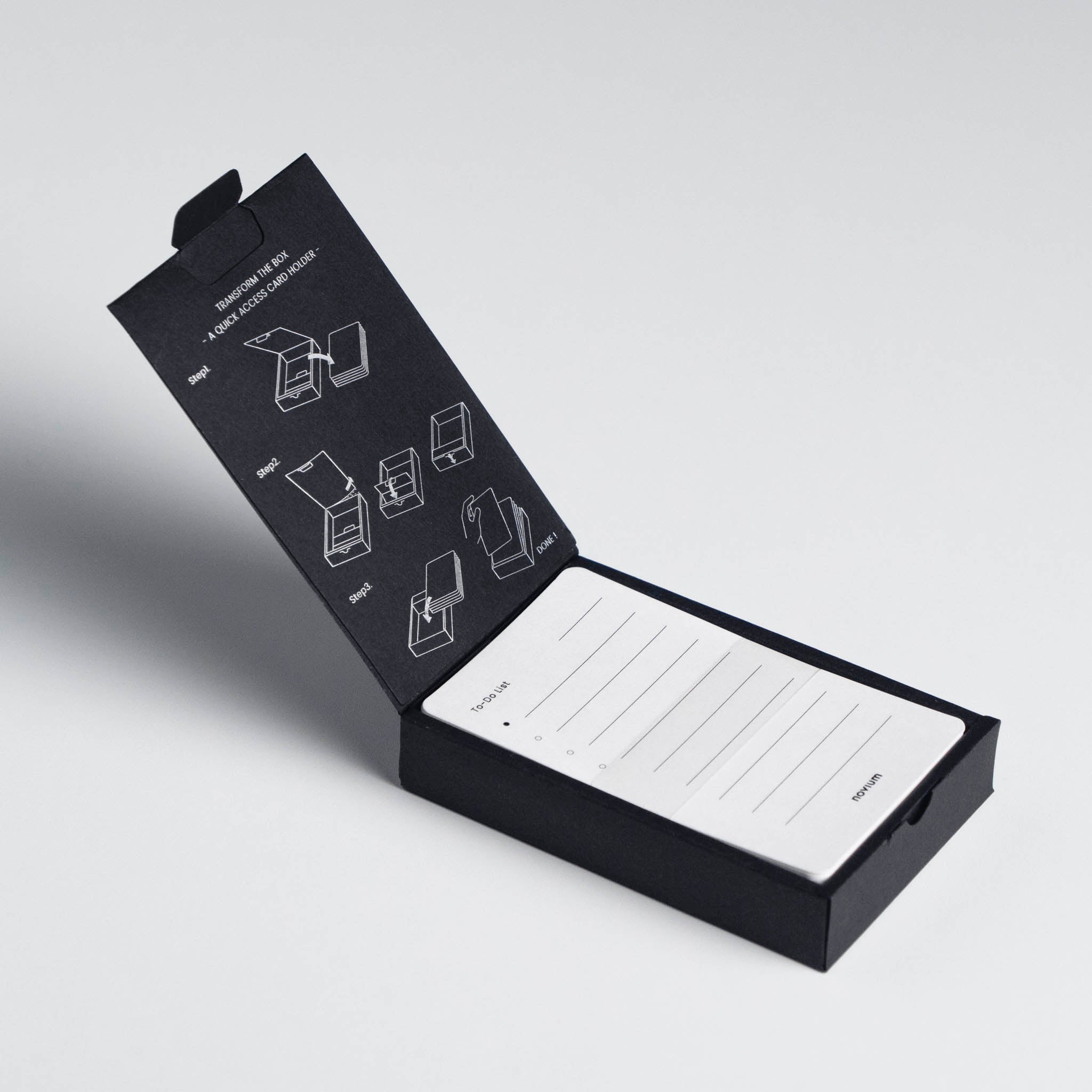 An unboxing of a novium productivity cards, instruction printed on inside of packaging with 60 to-do list cards