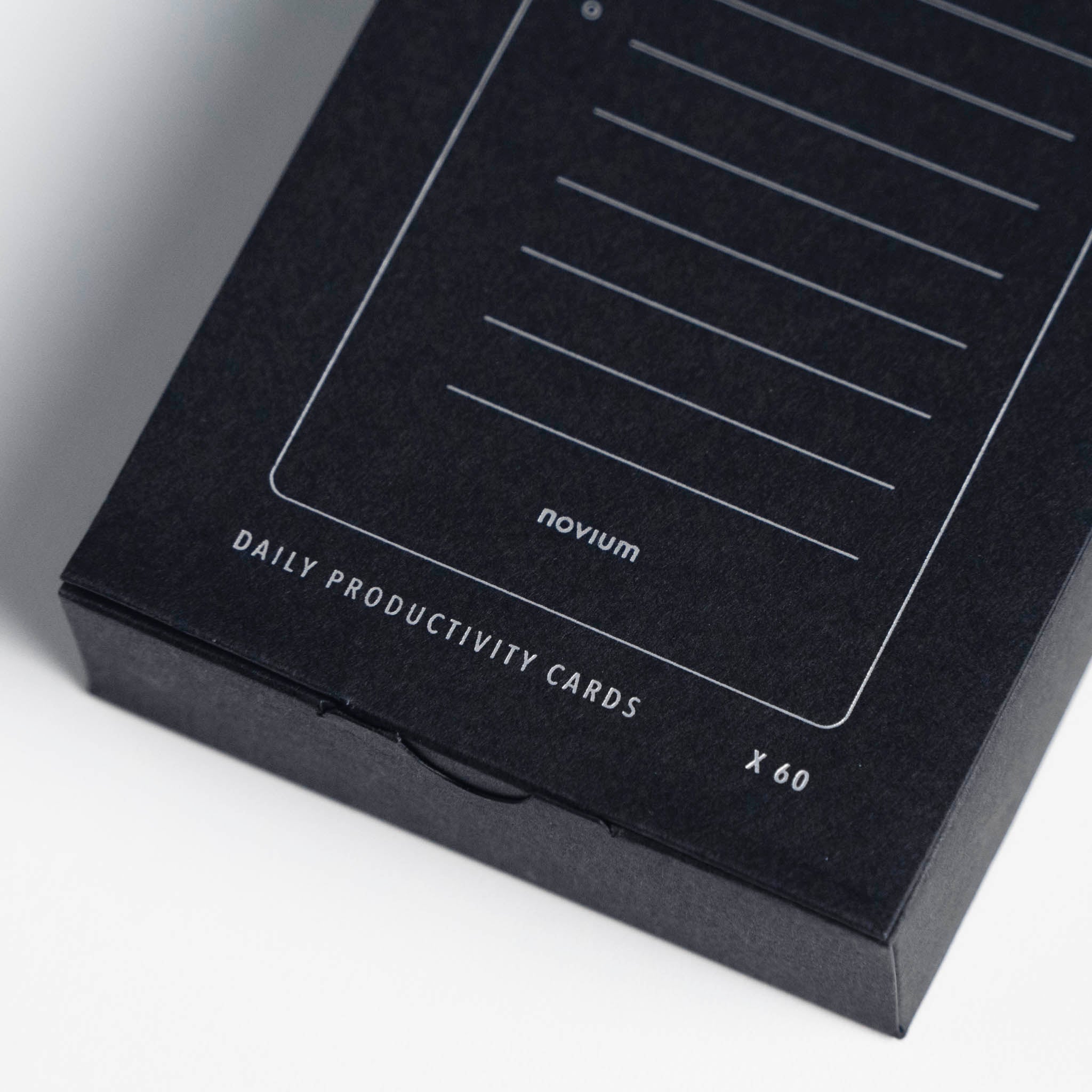 A close-up of the packaging of the productivity cards, which has the small silver text "Daily Productivity Cards" on it.